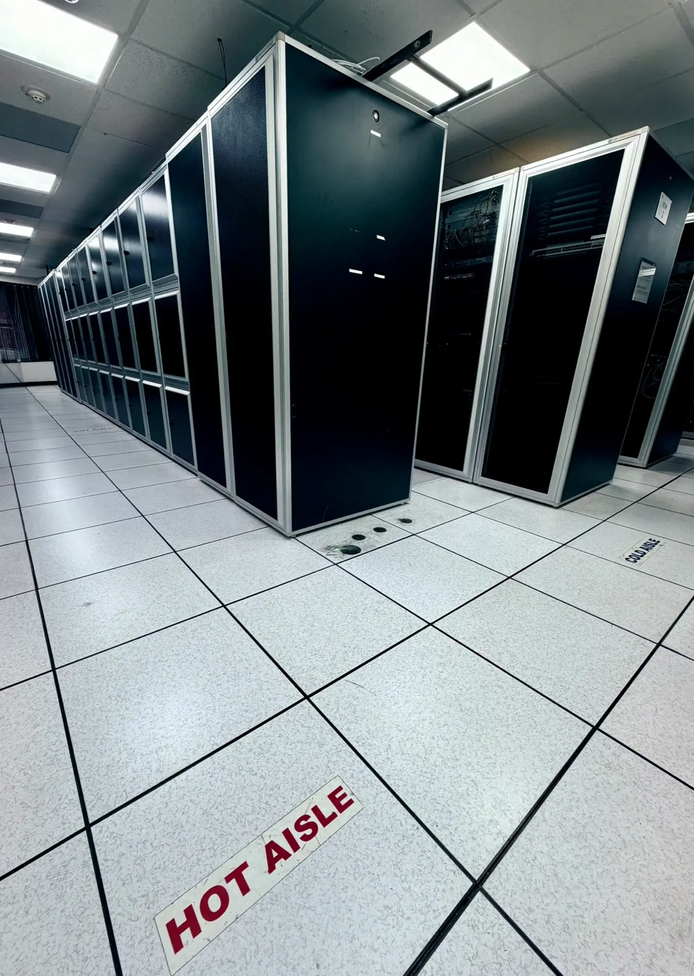 Hot aisle marking on the raised floor between cabinet rows