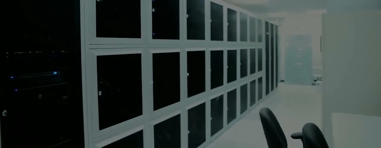 A row of locked, glass-fronted cabinets receding down the aisle at the Colo Solutions data center in downtown Orlando