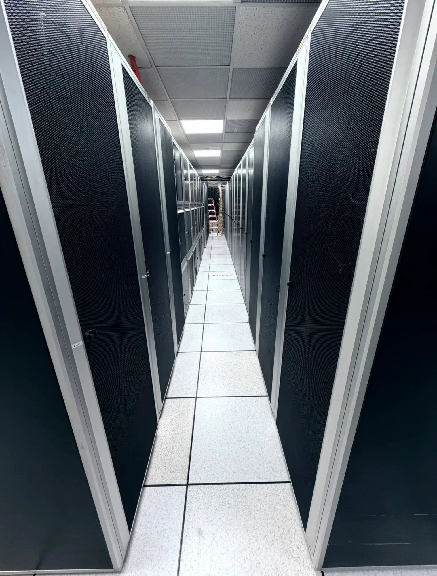 Cold aisle between locking cabinet rows